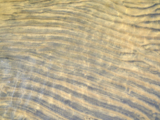 Beautiful natural wave pattern in the sea bottom sand