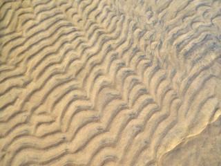 Beautiful natural wave pattern in the sea bottom sand