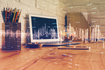Double exposure of graph and financial info and work space with computer background. Concept of...