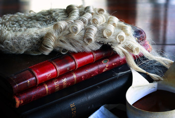 barrister's wig and collar with books on table