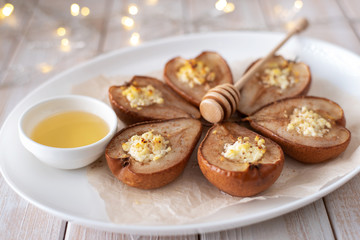 Fototapeta na wymiar Baked pears with cheese, cinnamon, honey