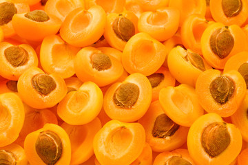 Ripe juicy orange apricots slices fruit background.