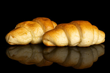 Group of two whole sweet golden mini croissant isolated on black glass