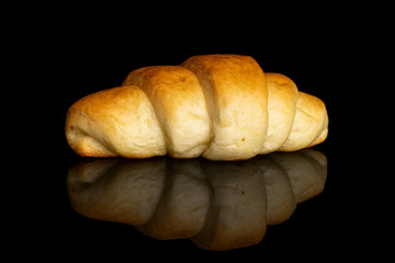 One whole sweet golden mini croissant isolated on black glass