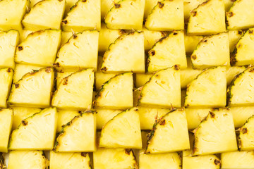 Pineapple juicy yellow slices background. Top view.