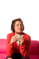 Young man drinking coffee and listening music