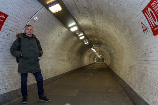 London : Man stands in Greenwich foot tunnel crosses beneath River Thames in East London, linking Greenwich (Royal Borough of Greenwich) on south bank with Isle of Dogs London Borough 