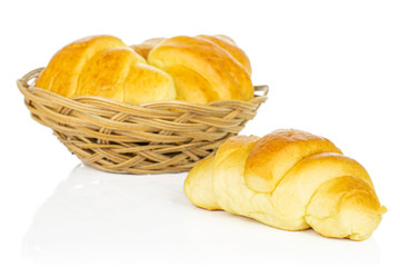 Group of four whole sweet golden mini croissant in basket isolated on white background