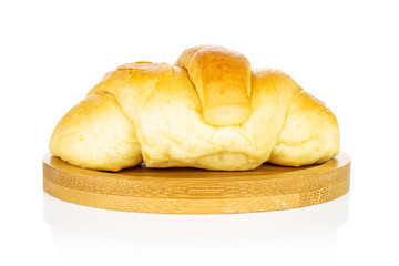 One whole sweet golden mini croissant on bamboo coaster isolated on white background