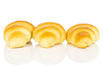 Group of three whole sweet golden mini croissant in row isolated on white background