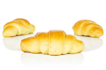 Group of three whole sweet golden mini croissant isolated on white background