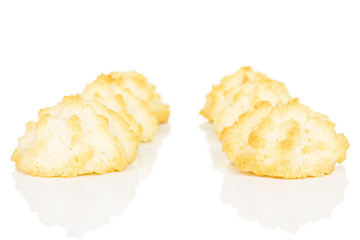 Group of six whole homemade golden coconut biscuit isolated on white background