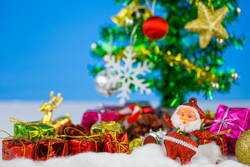 Close up of Santa claus droll with Christmas tree decoration background. Christmas day concept.