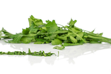 Lot of whole lot of pieces of chopped fresh green parsley isolated on white background