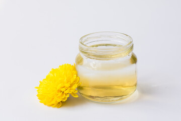 bottle with essential oil and fresh flowers isolated on white background