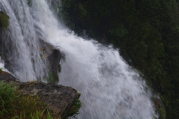 Close up of  the water falls of Cherrapunjee Eco park with lots of trees and greenery of the hills, selective focusing