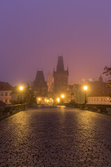 Fototapeta na wymiar Landscapes on Charles Bridge with Bridge Tower and Statues at sunrise in a foggy morning, Prague, Czech Republic, Europe