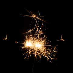 Firework sparkler burning isolated black background, shining fire flame, celebration festival happy holiday new year and merry christmas concept.