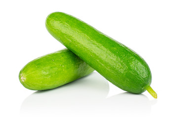 Group of two whole fresh green baby cucumber isolated on white background