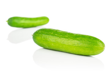 Group of two whole fresh green baby cucumber isolated on white background