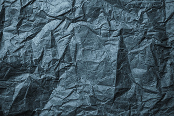 Crumpled black paper background. Messy wrinkled parchment. Wrapping paper texture, craft sheet, old card.