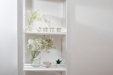 Wedding bouquet in glass vase on a shelf