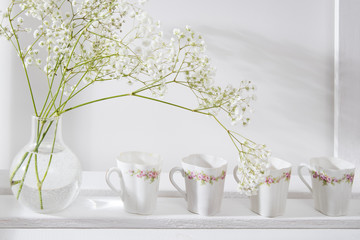 Wedding bouquet in glass vase on a shelf
