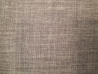 Fototapeta na wymiar canvas texture of the grey sofa