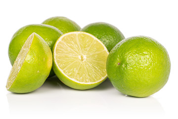 Group of four whole two halves of juicy sour green lime isolated on white background