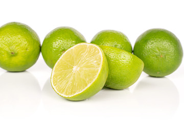 Group of four whole two halves of sour green lime isolated on white background