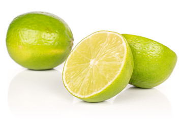 Group of one whole two halves of sour green lime isolated on white background