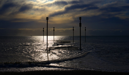 metal posts in water at low tide