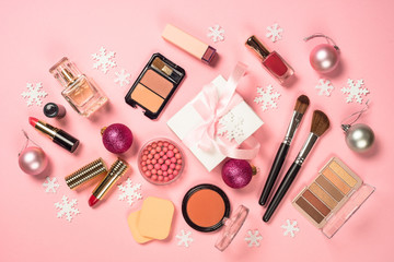 Makeup professional cosmetics with christmas decor on pink.