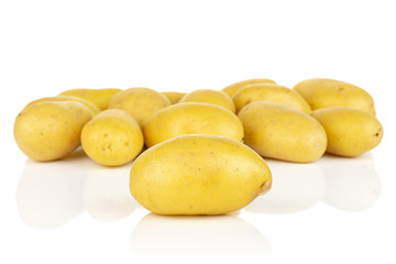 Lot of whole pale yellow potato isolated on white background