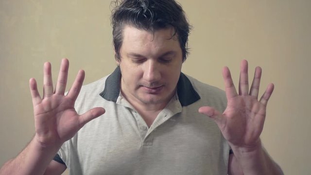 funny emotional man shows various grimaces resting against an invisible wall.cheerful middle aged male.video portrait