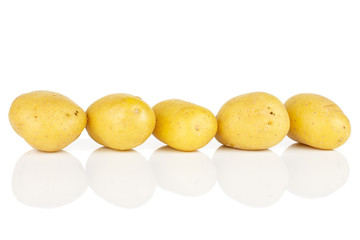 Group of five whole pale yellow potato isolated on white background