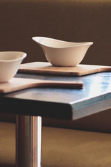 Retro style dining room interior details. White plate on the table