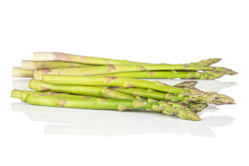 Lot of whole healthy green asparagus heap isolated on white background