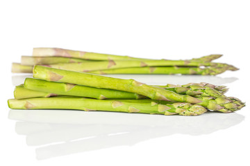 Lot of whole healthy green asparagus front focus isolated on white background