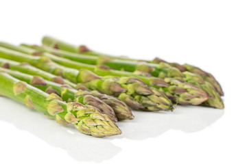 Lot of whole arranged healthy green asparagus isolated on white background
