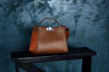 brown leather bag for business man with mockup metal decorative fastener on grey textured cement...