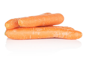 Group of four whole fresh orange carrot isolated on white background