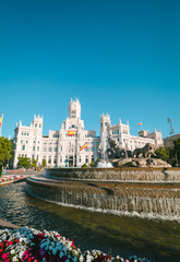 Cibeles fountain and Cibeles Palace at Plaza de Cibeles in Madrid in a beautiful summer day, Spain