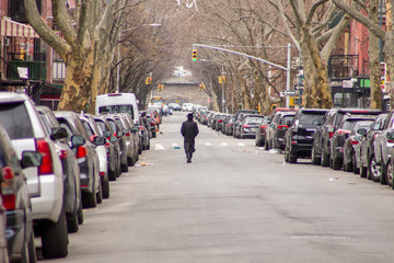 A man walks alone in an empty street at Brooklyn, New York