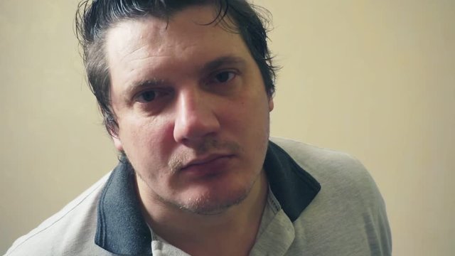 funny emotional middle aged man carefully looking at the camera