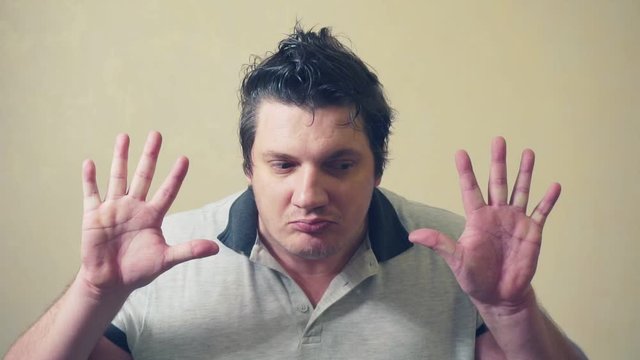 funny emotional man shows various grimaces resting against an invisible wall.cheerful middle aged male.video portrait