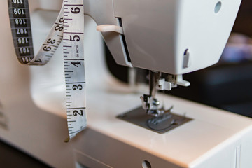 Sewing machine needle with measuring tape