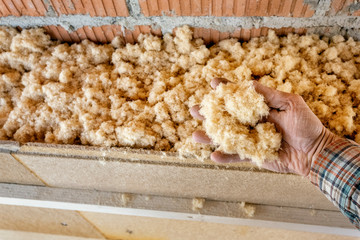 Insulating an Outside Wall, Hand Shows Wood Fiber Insulation Material
