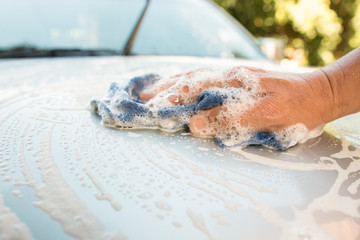 Man cleaning a car