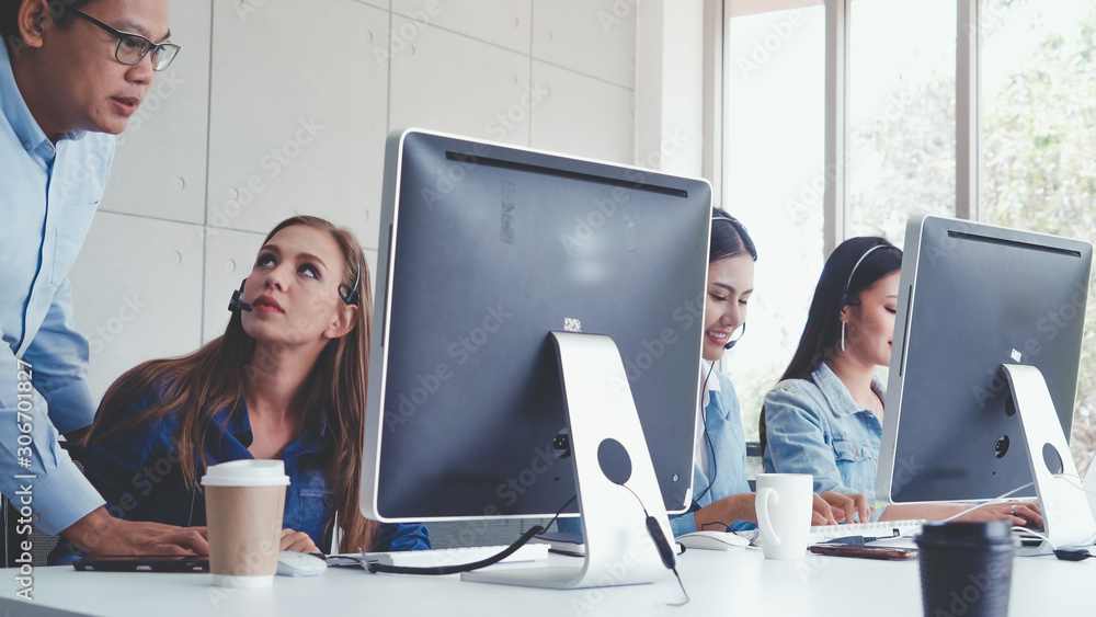 Aufkleber customer support agent or call center with headset works on desktop computer while supporting the cu